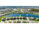 Aerial view of a lakeside home in a suburban community with lush landscaping and a nearby community pool at 5340 Bear Corn Run, Port Orange, FL 32128