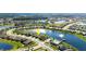 Aerial view of a lakeside home featuring a pool and pier in a suburban community with lush landscaping at 5340 Bear Corn Run, Port Orange, FL 32128