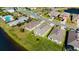 A picturesque aerial view of a community with lush green lawns and access to a pool and waterfront at 5340 Bear Corn Run, Port Orange, FL 32128