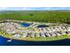 An aerial view of a lakeside home with a pool and pier, nestled in a beautiful suburban community at 5340 Bear Corn Run, Port Orange, FL 32128