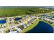 An aerial view of a suburban lakeside home with manicured lawn, a pool, and nearby highways at 5340 Bear Corn Run, Port Orange, FL 32128