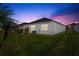 A lush backyard with a patio extending from the house at 5340 Bear Corn Run, Port Orange, FL 32128