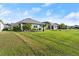 A lush backyard with a well-maintained lawn and tropical landscaping at 5340 Bear Corn Run, Port Orange, FL 32128