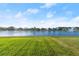 Picturesque backyard view overlooking a serene lake and lush green lawn at 5340 Bear Corn Run, Port Orange, FL 32128