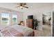 Comfortable bedroom with lake views, ceiling fan, and neutral decor at 5340 Bear Corn Run, Port Orange, FL 32128