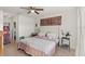 Bright bedroom with a decorative rug, ceiling fan and neutral decor at 5340 Bear Corn Run, Port Orange, FL 32128