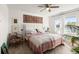 Cozy bedroom with water views, a decorative rug, and a ceiling fan at 5340 Bear Corn Run, Port Orange, FL 32128