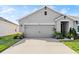 Charming single-Gathering home with a well-maintained lawn and gray two car garage at 5340 Bear Corn Run, Port Orange, FL 32128