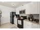 Modern kitchen features stainless steel appliances and white cabinetry at 5340 Bear Corn Run, Port Orange, FL 32128