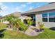 Cozy covered patio with tropical landscaping and a tiki umbrella, perfect for outdoor relaxation at 5340 Bear Corn Run, Port Orange, FL 32128