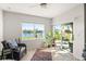 Inviting sunroom with water views, tile flooring, and comfortable seating area at 5340 Bear Corn Run, Port Orange, FL 32128
