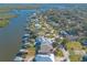 Aerial view of waterfront home with private dock and lush landscaping at 5727 Riverside Dr, Port Orange, FL 32127