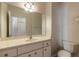 Clean bathroom with single vanity, toilet, and updated mirror at 5727 Riverside Dr, Port Orange, FL 32127