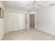 Well-lit bedroom with double-door closet and access to another room at 5727 Riverside Dr, Port Orange, FL 32127