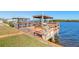 Private wooden boat dock with covered storage and lift at 5727 Riverside Dr, Port Orange, FL 32127