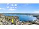 Wide aerial view of waterfront condos with mature trees and bright blue skies above at 632 Sausalito Blvd, Casselberry, FL 32707