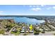 Aerial view of lakeside villas with meticulously maintained lawns under a partly cloudy blue sky at 632 Sausalito Blvd, Casselberry, FL 32707