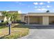 View of the front exterior, showing the address, covered parking, and manicured lawn at 632 Sausalito Blvd, Casselberry, FL 32707