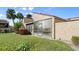 A building and attached glassed-in porch, surrounded by shrubs, grass, and palm trees at 632 Sausalito Blvd, Casselberry, FL 32707