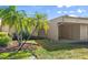 Manicured front lawn of a single-story home with an attached carport and vibrant palm trees at 632 Sausalito Blvd, Casselberry, FL 32707