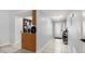 Hallway leading to the entry door with white cabinets and black appliances at 632 Sausalito Blvd, Casselberry, FL 32707