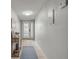 Hallway featuring neutral walls, tiled floor, and front door at the end of the hall at 632 Sausalito Blvd, Casselberry, FL 32707