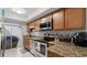 Modern kitchen featuring granite countertops, stainless steel appliances, and ample cabinet space at 632 Sausalito Blvd, Casselberry, FL 32707