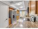 Kitchen view with granite countertops, stainless appliances, and access to outdoor patio at 632 Sausalito Blvd, Casselberry, FL 32707