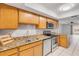 Kitchen boasts stainless steel appliances, granite countertops, and natural wood cabinets at 632 Sausalito Blvd, Casselberry, FL 32707