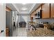 Updated kitchen featuring stainless steel appliances, wood cabinets, and sliding doors to the patio at 632 Sausalito Blvd, Casselberry, FL 32707