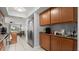 Well-lit kitchen with wood cabinets, granite counters and stainless steel refrigerator at 632 Sausalito Blvd, Casselberry, FL 32707