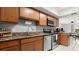 Well-lit kitchen featuring granite countertops and stainless steel appliances against neutral-colored walls at 632 Sausalito Blvd, Casselberry, FL 32707