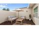 Outdoor patio features a seating area with umbrella, a small plant, and neutral tones for a relaxed ambiance at 632 Sausalito Blvd, Casselberry, FL 32707