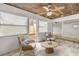 Cozy sunroom with wood ceiling, tile floors, bright windows, and comfortable seating area at 632 Sausalito Blvd, Casselberry, FL 32707