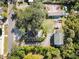 Aerial view showing a house, detached guest house, driveway, and large oak tree at 636 Faulkner St, New Smyrna Beach, FL 32168