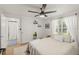 Main bedroom with ceiling fan, a walk-in closet and neutral decor at 636 Faulkner St, New Smyrna Beach, FL 32168