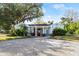 Charming single story home with light blue exterior, white trim, and a paver driveway at 636 Faulkner St, New Smyrna Beach, FL 32168