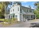 Two-story light green house with screened porch at 636 Faulkner St, New Smyrna Beach, FL 32168