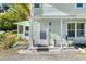 Inviting front porch with potted plants at 636 Faulkner St, New Smyrna Beach, FL 32168