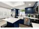 Modern kitchen with white quartz island and blue shaker cabinets at 636 Faulkner St, New Smyrna Beach, FL 32168