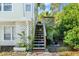 Stairs leading to a deck, surrounded by greenery at 636 Faulkner St, New Smyrna Beach, FL 32168