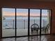 Living room with view of waterfront balcony and bridge at 654 Marina Point Dr # 654, Daytona Beach, FL 32114