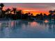 Resort-style pool at sunset with palm trees and lounge chairs at 667 Margaritaville Ave, Daytona Beach, FL 32124