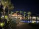 Night view of community pool with tiki bar and lounge chairs at 667 Margaritaville Ave, Daytona Beach, FL 32124