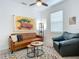 Cozy den featuring a leather couch and fun wall art at 667 Margaritaville Ave, Daytona Beach, FL 32124