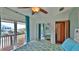 Bedroom with private balcony, ocean view and ceiling fan at 6911 Turtlemound Rd, New Smyrna Beach, FL 32169