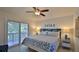 Main bedroom with sliding doors to private deck at 6911 Turtlemound Rd, New Smyrna Beach, FL 32169