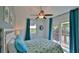 Bedroom with balcony access and ceiling fan at 6911 Turtlemound Rd, New Smyrna Beach, FL 32169