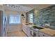 White kitchen with modern appliances and tile backsplash at 6911 Turtlemound Rd, New Smyrna Beach, FL 32169