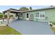 Backyard patio with grey concrete and wooden gazebo at 705 Wayne Ave, New Smyrna Beach, FL 32168